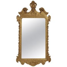 an ornate gold framed mirror against a white background