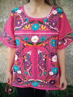 Beautiful PINK cotton blouse completely embroidered by hand, not by machine. It has colorful flower embroidery. All blouses have variation in embroidery because they are made entirely by hand by Mexican artists from Oaxaca. There is no blouse the same one to another. Original designs. I'm sure you will love your blouse and will receive many compliments. The style of the blouse is boho, hippie ideal for women of any age and for any occasion. FRIDA STYLE. XL Bust (47 inches bust) Hips (49 inches h Pink Bohemian Style Embroidered Top For Spring, Spring Pink Bohemian Embroidered Top, Pink Hippie Blouse For Festivals, Pink Bohemian Embroidered Top With Floral Design, Pink Short Sleeve Embroidered Cotton Top, Pink Floral Print Festival Blouse, Pink Folk Blouse With Floral Embroidery, Pink Folk Blouse For Spring, Folk Style Pink Blouse With Floral Embroidery