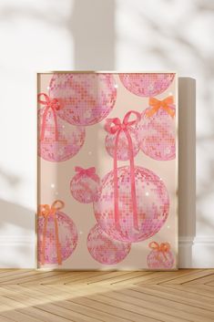 a pink gift bag sitting on top of a wooden floor