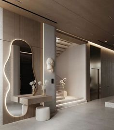 a bathroom with a sink and mirror next to a stairway leading up to the second floor