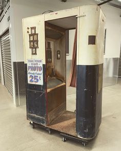 an outhouse with a sign on the door that says take your own photo 25 cents