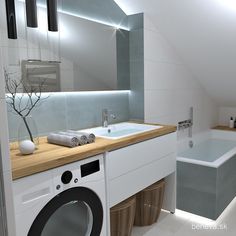 a washer and dryer in a bathroom with a skylight over the bathtub