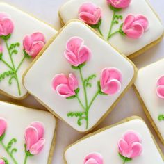 several decorated cookies with pink flowers on them