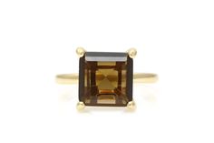 A ring jewelry for women by Anemone that highlights an earthy brown Smoky Quartz, set in 14k gold-filled single band and delicate prongs. This Quartz ring is also available in 14k solid gold band and Sterling silver. This piece is finished in high polished shine. ☛ 𝒜𝐵𝒞 - Add Engraving - https://etsy.me/3CLxYPZ ☛ Ring size - Select the size you would like from the drop down menu ♥ Gemstone Type - Smoky Quartz ♥ Gemstone Size - 10mm ♥ Gemstone Cut - Square ♥ Metal Type (Main Photo) - 14k Gold F Raw Engagement Ring, Brown Engagement Rings, Brown Smoky Quartz Rings For Gift, Elegant Smoky Quartz Brown Rings, Smokey Quartz Ring, Brown Smoky Quartz Gemstone Jewelry, Luxury Gold Smoky Quartz Jewelry, Ring Proposal, Smoky Quartz Ring