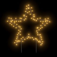 a lighted star on a black background with some lights in the shape of a star