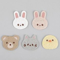 four crocheted animal coasters in various colors