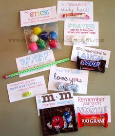 some candy bar wrappers are arranged on a table with cards and magnets attached to them