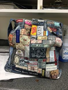 a purse made out of old newspaper is sitting on the floor