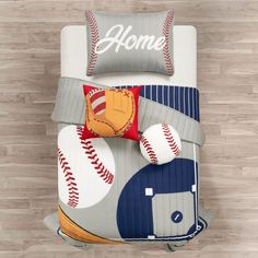 a baseball themed comforter set on a wood floor with pillows and pillowcases