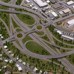 an aerial view of a highway intersection with multiple lanes and roundabouts in the center