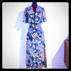 This 70’s Maxi Dress With A Cute Coverlet Is So Feminine And Beautiful! It Has Spaghetti Straps And A Sweat Heart Neckline With Ruching In The Center, The Fabric Is A Sheer Blend Of Cotton And Polyester In A Teal And Purple Floral Print, The Top Is Lined, It Zips Up The Back With A Nylon Zipper. Material: 65% Polyester 35% Cotton Color/Print: Purple, Teal Floral Maker: Unmarked Where: Us Era: 70's Size: S Measurements Available Condition: Very Good, Pre-Owned Vintage Flowy Midi Dress With Short Sleeves, Vintage Maxi Dress For Dress Down In Spring, Flowy Vintage Midi Dress, Spring Purple Lined Midi Dress, Vintage Spring Midi Dress, Vintage Flowy Midi Dress For Spring, Vintage Flowy Midi Dress For Garden Party, Lined Purple Midi Dress For Summer, Purple Lined Midi Dress For Summer