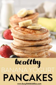 healthy banana yogurt pancakes on a plate with strawberries and bananas in the background