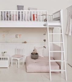 a white bunk bed sitting next to a desk and chair