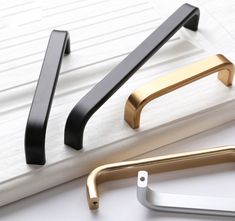 three different types of handles on a white surface