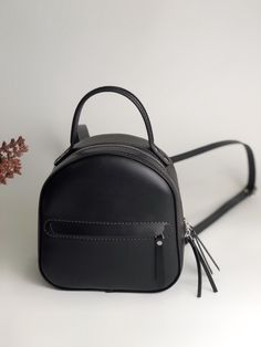 Small black backpack women made of genuine high-quality leather will not only dilute your style, but also free your hands from things. Green convertible backpack easily turns into a shoulder bag. Please note that due to the fact that each mini backpack is handcrafted from calfskin, sometimes they may have slight differences in color or tiny marks. This is completely natural. Product information: The convertible backpacks for women has adjustable shoulder straps and a convenient carry handle, straps have carbine, which allows you to detach one of the straps and carry the backpack over your shoulder. It has a main compartment, an inner pocket on the back of the bag, an outer zip pocket in the front. Material: Italy Vegetable tanned leather Skin color: outer color green, inside the backpack i Gift Backpack With Zipper Closure, School Bags With Leather Lining, Backpack With Zipper Closure As Gift, Backpack Gift Bag With Zipper Closure, Leather Backpack Perfect For Gift, Luxury Backpack Bag As Gift, Leather Backpack Bag For Gift, Leather Backpack Gift, Leather Backpack Suitable As A Gift