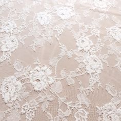 an image of white lace with flowers on it