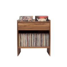 a wooden shelf with various records and cds on it's sides, against a white background