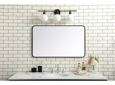 a bathroom vanity with a large mirror above it