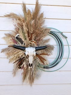 Elevate your home decor with our rope wreath, a stunning piece of western wall art featuring an Aztec cow skull design. This lasso wreath adds a rustic touch to any farmhouse decor, perfect for enhancing your living room with a unique western longhorn sign. KEY FEATURES *Approximate Dimensions: 1.38" H x 19.63" W x 4.31" D* Bull Head  * Choose your florals  RUSH MY SHIPPING USE THIS LINK! https://jamesonropeandco.etsy.com/listing/1691702946/rush-my-shipping CUSTOMIZE MY WREATH  https://jamesonro Dining Room Western Decor, Wreath On Wall Southwest, Longhorn Skull Door Hanger, Western Xmas Wreath, Bull Head Wreath, Western Wreaths Farmhouse, Cowboy Wreath Nursery, Christmas Wreaths Western, Rope And Wood Western Wall Art