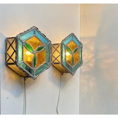 two stained glass wall lights on a white wall