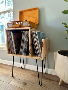 an old record player sits on top of a wooden shelf