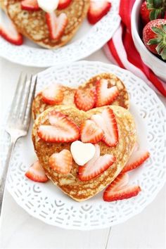 two heart shaped pancakes with strawberries on top