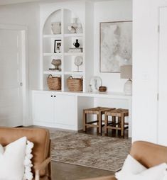 a living room filled with furniture and white walls