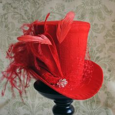 This striking yet elegant burlesque mini top hat is covered with beautiful bright red silk shantung. It is embellished with matching red veil, a luxurious spray of curled ostrich plums and a sparkling flower shaped rhinestone button. Also available in white,black and ivory here : https://www.etsy.com/shop/BizarreNoir?ref=seller-platform-mcnav&section_id=14329940 If you're interested in another color, please, send me a message to talk about your options. This mini top hat is fully lined with Fitted High Crown Hat For Carnival, Fitted High Crown Costume Hat For Carnival, Red Tall Crown Costume Hat For Party, Gothic Top Hat With High Crown For Parties, Gothic Mini Hat For Carnival Party, Fitted Steampunk Party Hat, Fitted Party Costume Hat With Tall Crown, Fitted Steampunk Costume Hat For Party, Fitted Tall Crown Hat For Party