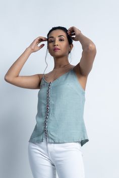 "Linen top for women, Grey top, Linen tank top, Tops for summer, Made to order, Custom made, Plus size Wear these linen tops with tight fitted jeans or loose bottoms.. these linen tops are meant to make you look more up to date with fashion with a touch of Indian folk embroidery. -Model height: 5'3\" wearing size S -Top length: 22\" -0.5\" strap -Hand embroidered buttons -Closure: Front buttons" Women White Top, Cream Linen Pants, Embroidered Buttons, Tops For Summer, Fitted Jeans, Linen Tops, Loose Fit Blouse, Linen Tank Top, Linen Tank