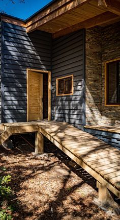 a wooden bench sitting in front of a building