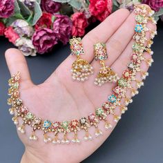 Featuring an evergreen navratna jadau necklace with jhumkis made in 22ct gold.  The necklace weighs 25.35 GMs including 3.37 GMs of hanging pearls.  The jhumkis weigh 14.28 GMs including 1.82 GMs of hanging pearls. Price Breakup Summary Component Rupees % of Total 22k Gold 147,928 74.5% Stones & Beads 18,243 9.2% M Festive Multicolor 22k Gold Bridal Necklace, Multicolor 22k Gold Necklaces For Celebration, Multicolor 22k Gold Kundan Necklace For Celebration, Multicolor 22k Gold Temple Jewelry Bridal Necklace, Multicolor 22k Gold Kundan Temple Jewelry Necklace, Multicolor 22k Gold Bridal Necklace For Festivals, Multicolor 22k Gold Necklace For Diwali, Multicolor 22k Gold Temple Necklace For Festivals, Multicolor 22k Gold Bridal Necklace For Celebration