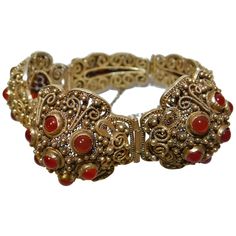 This early 20th century Chinese vermeil bracelet has 26 carnelian or pink coral stones. Vintage Carnelian Jewelry For Weddings, Vintage Carnelian Jewelry For Wedding, Red Carnelian Vintage Jewelry, Vintage Red Carnelian Jewelry, Antique Red Bracelet For Formal Occasions, Red Antique Bracelet For Formal Occasions, Gold Carnelian Jewelry For Wedding, Yellow Gold Carnelian Wedding Jewelry, Victorian Carnelian Jewelry For Formal Occasions