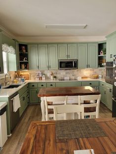 a kitchen with wooden floors and green cabinets