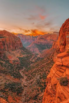 the sun is setting over canyons and mountains in the desert, with trees on both sides