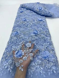 a person's hand on top of a blue dress