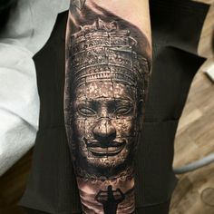 a man with a tattoo on his arm has a black and white image of a buddha