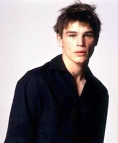 a young man in a black shirt posing for a photo