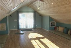 an empty living room with wood flooring and skylights in the ceiling is shown