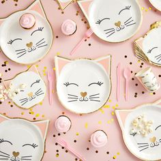 pink and gold table setting with cat plates