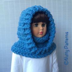 a doll wearing a blue knitted scarf with hood on it's head and neck