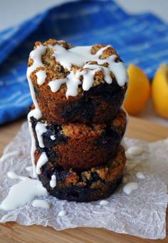 three blueberry muffins stacked on top of each other with white icing