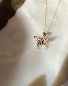 Give her the gift of wings with this beautiful butterfly necklace. DETAILS - 14k yellow gold butterfly with rhodium plating - Chain option is a 14k yellow gold cable chain - Chain style may vary slightly - Approximately 13/16 inch wide x 7/8 inch tall (including bail) VARIATIONS If you require any variation of this style (a different style chain, longer chain, etc.) feel free to message us. We will do our best to accommodate you. Additional costs may apply depending on the variation. POLICY We d Luxury Gold Butterfly Charm Necklace, Delicate White Gold Butterfly Charm Necklace, Elegant Butterfly Charm Jewelry, Butterfly Shaped Yellow Gold Sterling Silver Jewelry, Elegant Wing-shaped Jewelry With Butterfly Charm, Elegant Wing-shaped Butterfly Charm Jewelry, Yellow Gold Butterfly-shaped Sterling Silver Jewelry, Yellow Gold Sterling Silver Butterfly Jewelry, Gold Sterling Silver Butterfly Necklace With Adjustable Chain