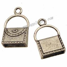 two silver metal charms with an open handle