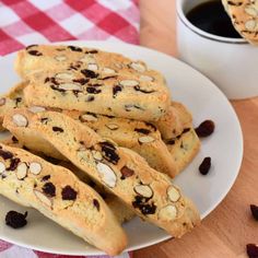 cookies and raisins on a plate next to a cup of coffee