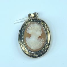 This Lovely Pendant Locket Is Crafted In Wonderful Detail Polished 14k Yellow Gold. Center Set Hand Carved Shell Cameo In Amazing Detail. Fine Foliage Etching Embellished Around The Cameo. The Locket Can Hold Two Photos, Can Be Worn As Pendant. 1 1/4" X 7/8", Weight 7.6gm, Tested For 14k Vintage Gold Jewelry For Opera, Formal Yellow Gold Cameo Jewelry, Antique Gold Jewelry For Opera, Antique Cameo Yellow Gold Jewelry, Antique Yellow Gold Cameo Jewelry, Heirloom Cameo Jewelry In Yellow Gold, Antique Yellow Gold Intaglio Jewelry, Classic Gold Cameo Jewelry, Heirloom Yellow Gold Cameo Jewelry