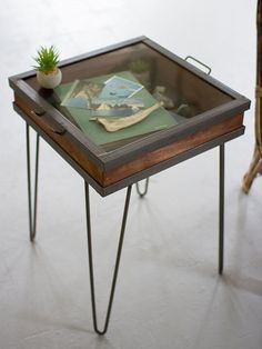 a small table with a magazine on it next to a wicker chair and cane legs