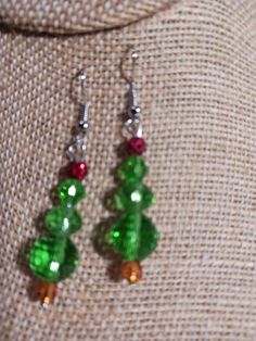 Beaded Christmas Tree earrings.  Approximately 1 1/2 inches in length.  Great small gift or stocking stuffer. Christmas Gift Jewelry With Faceted Beads, Green Dangle Christmas Jewelry, Green Beaded Earrings For Holiday Gift, Green Dangle Earrings For Holiday, Green Dangle Earrings For Holidays, Green Beaded Earrings For Holidays, Green Drop Earrings For Holiday, Holiday Handmade Green Jewelry, Green Christmas Drop Earrings Jewelry