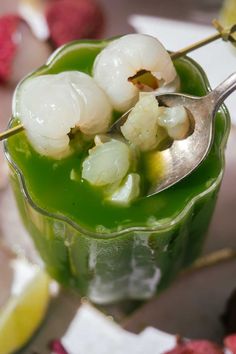 Scooping lychee from a glass of matcha soda with a spoon. Mocktail Drink, Mocktail Drinks