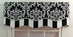 the black and white valance is hanging on the wall