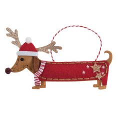 a wooden ornament with a dog wearing a santa hat and reindeer antlers